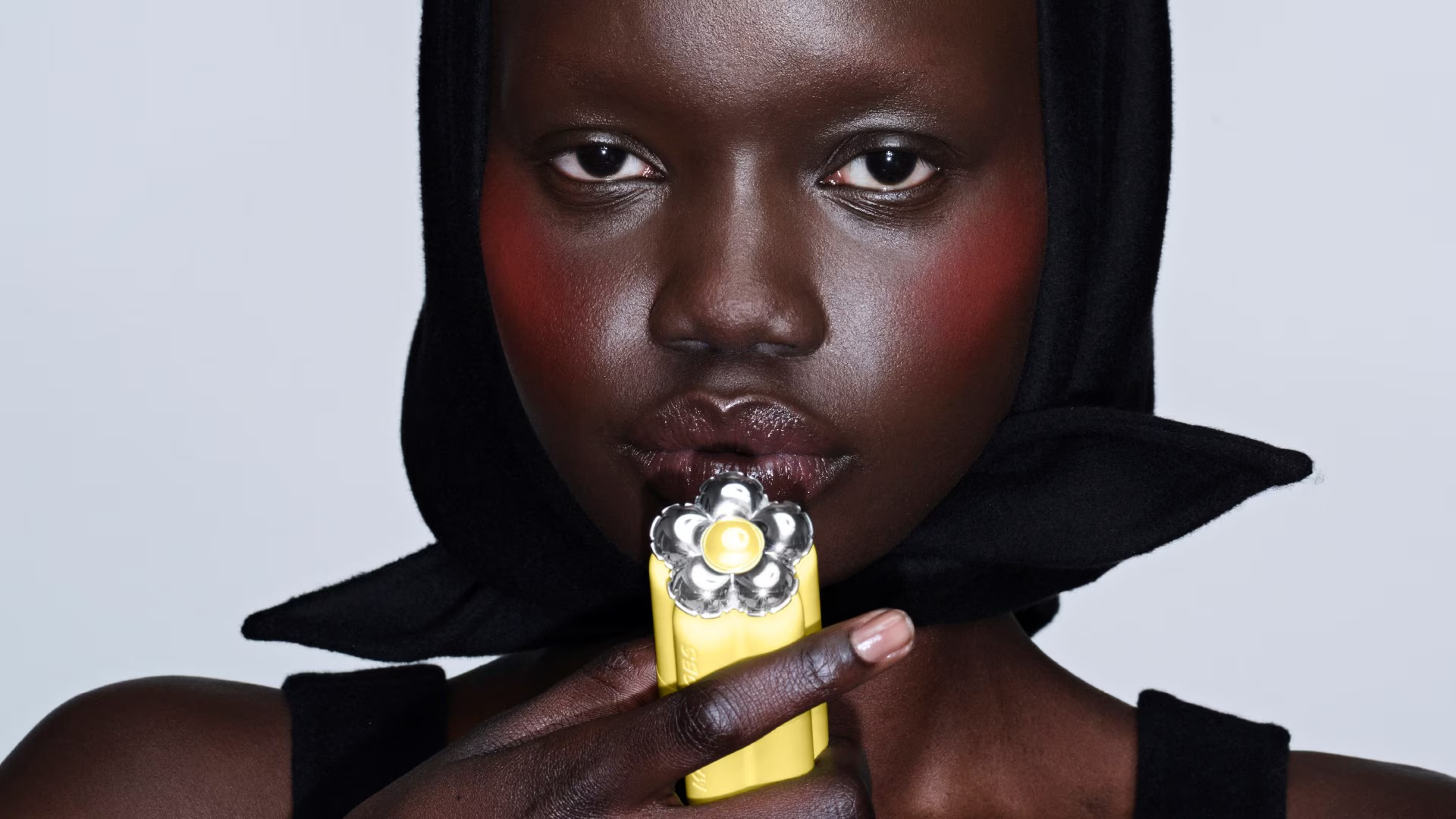 Bite Me Branding — hooded model with yellow daisy lipstick