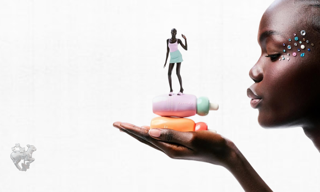 A model balanced atop squishy pastel bottles, held in an open palm